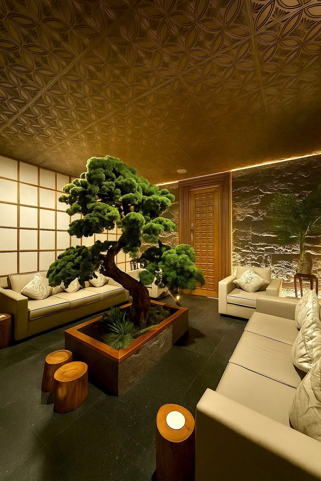 Manor branch lounge with a bonsai centerpiece and warm golden lighting