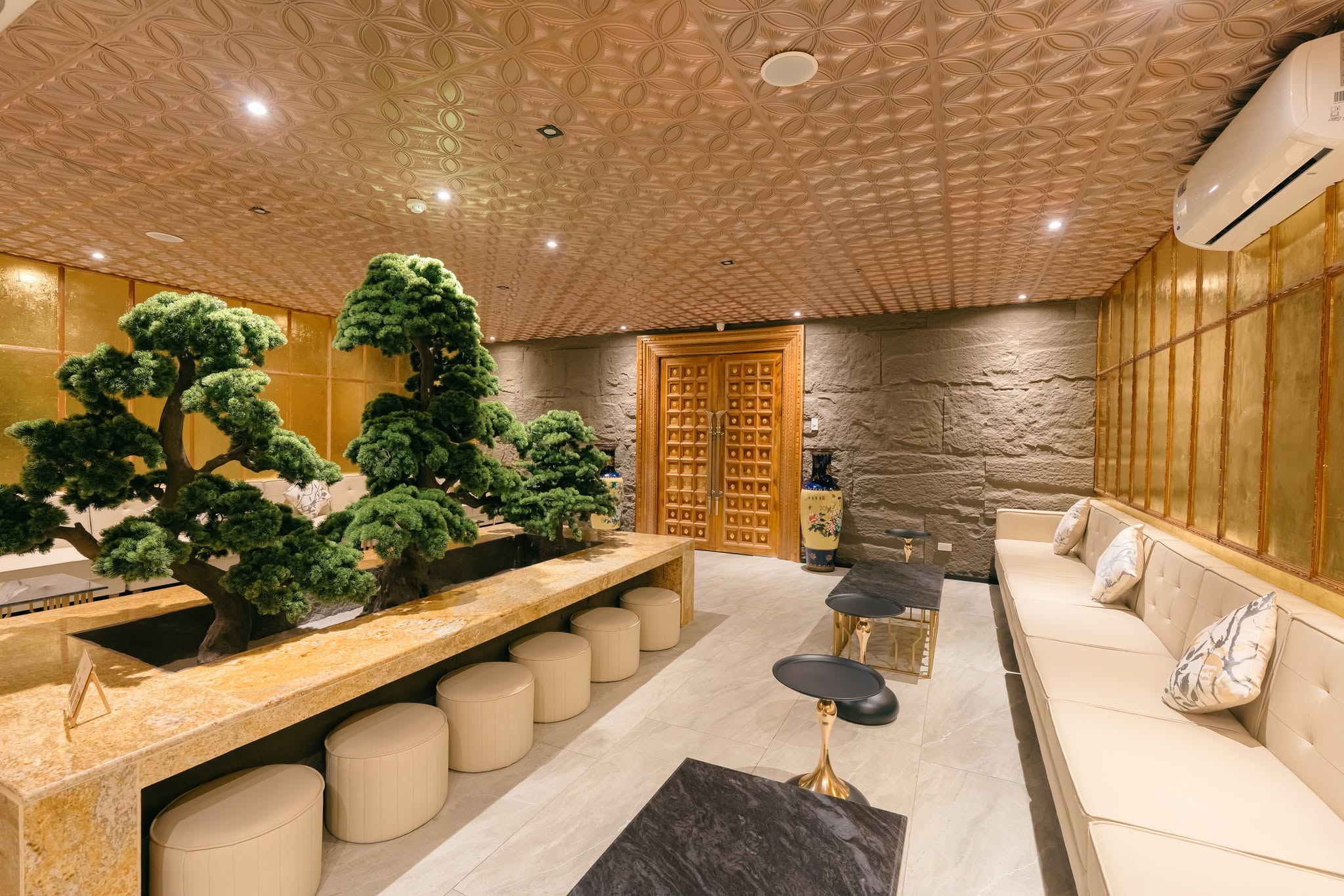 Oakridge branch's bright lounge with natural wood and a bonsai centerpiece